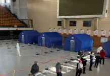 Should China’s Increase in COVID-19 Virus Outbreak be a Concern to the World, or the CCP? People line up at a makeshift fever clinic